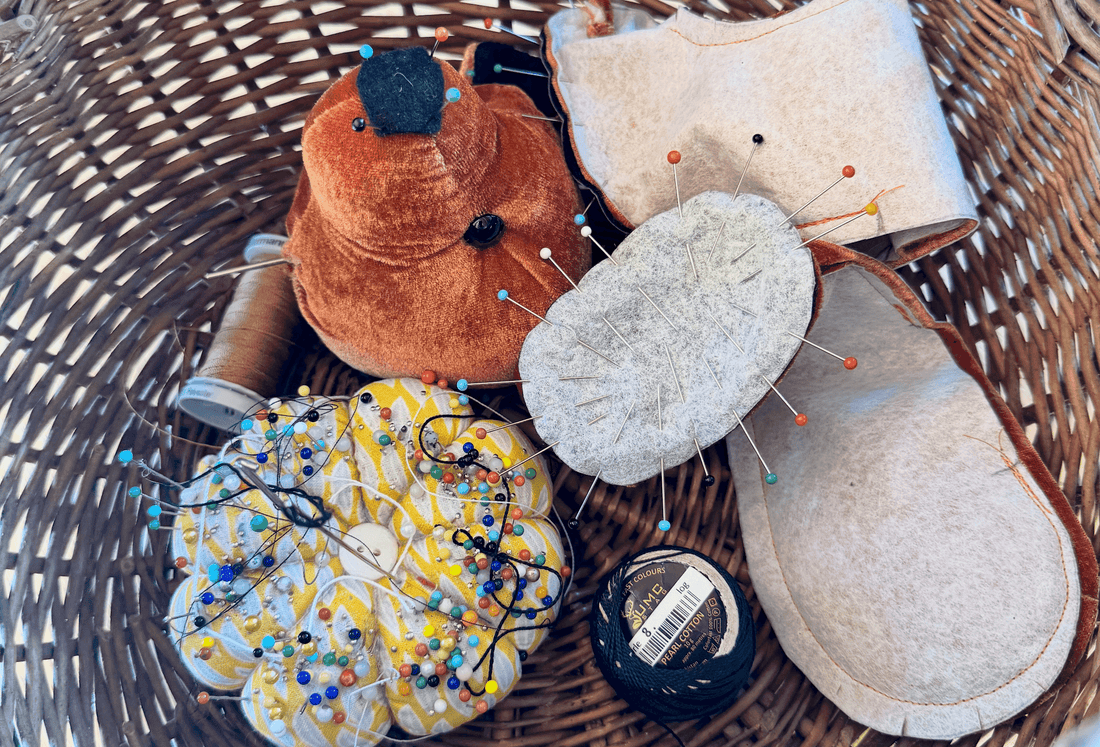 A brown wicker basket of materials used to create a soft toy bear.